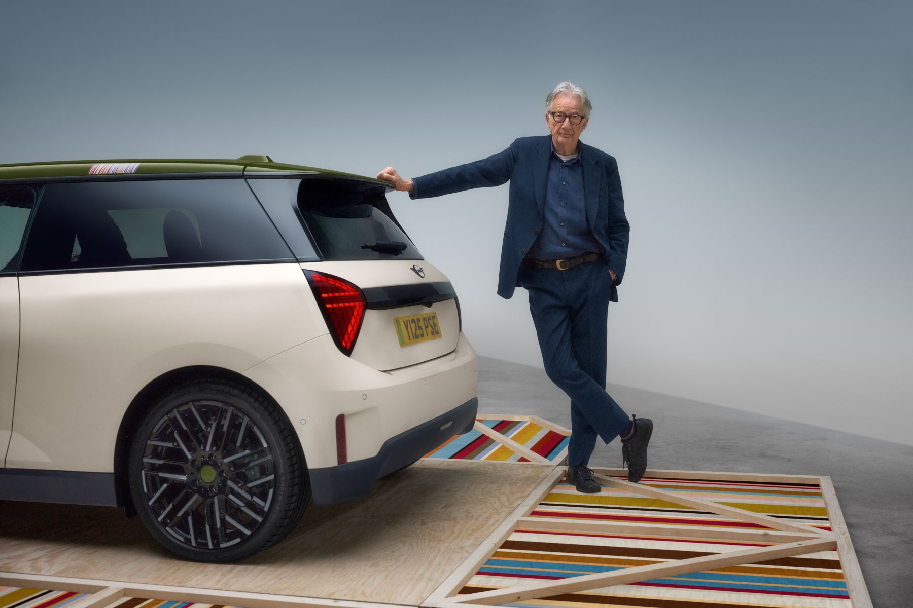 Paul Smith poses leaning against the special edition model